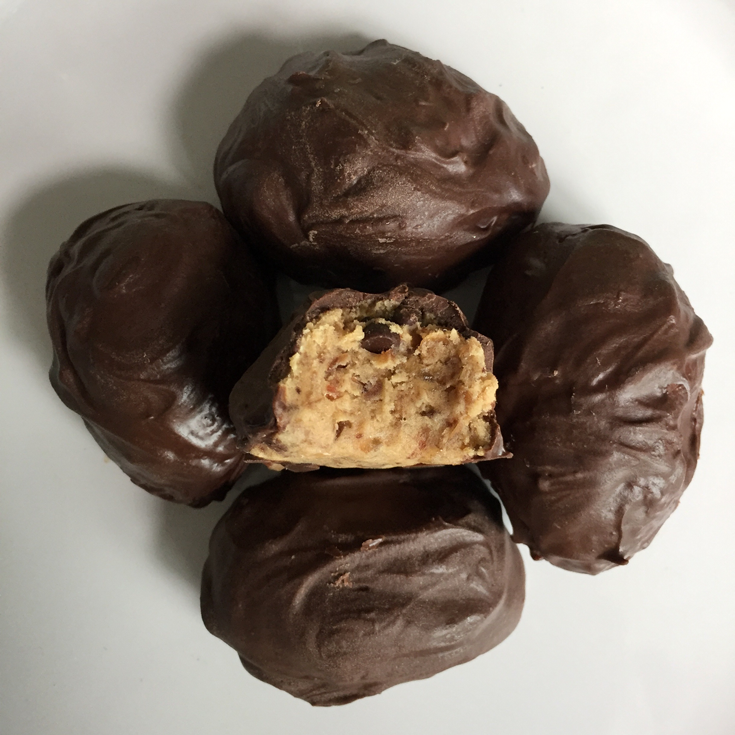 Looking for edible protein cookie dough? Try this five ingredient protein paleo cookie dough - 5 minutes to make, no bake, egg-free, and vegan protein balls with NO refined sugar! This creamy, smooth, and deliciously rich recipe is filled with protein and is paleo, low carb, vegan, paleo, gluten free, dairy free, and sugar free, and so festive for Easter! Check it out now! #glutenfree #vegan #healthy #lowcarb #cookiedough #paleo #easter #spring